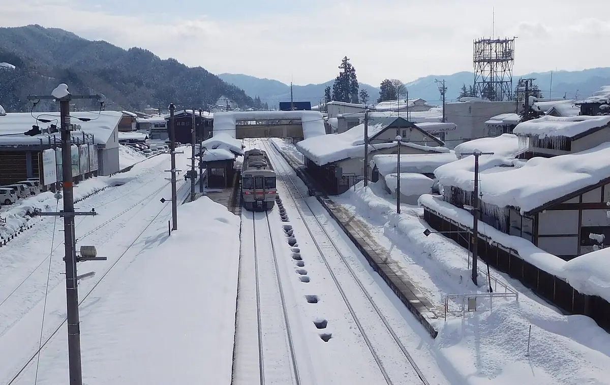 Snow on the platforms at Hida-Furukawa Station, with a train alongside